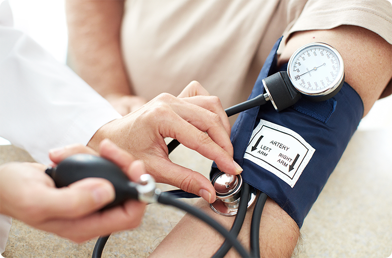 Provider checking a patient's blood pressure